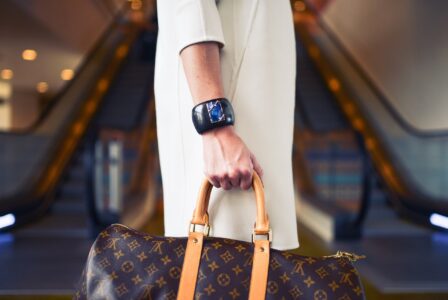 Stylish woman with designer handbag during luxury shopping on Düsseldorf's Königsallee
