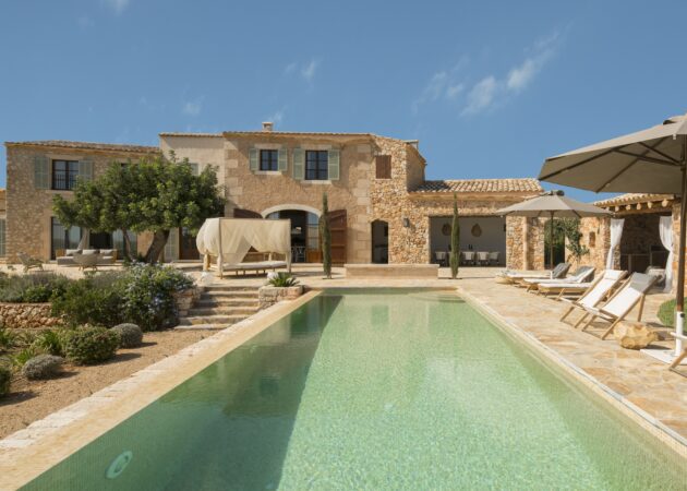 Luxury villa in Mallorca with pool, sun loungers and boho-style Bali bed